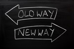 Old Way, New Way written on a blackboard with arrows pointing in the direction of the past and the future. A concept for adapting to change, improvement and development for the self or the business